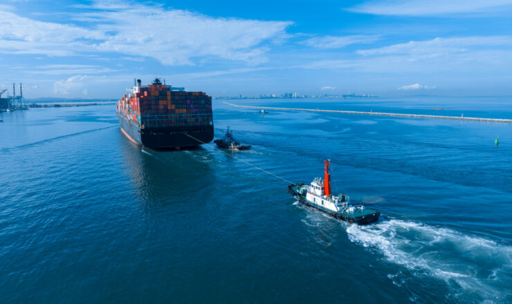 Tug boat Drag Pull Cargo container Vessel ship for Slow Velocity down or Braking ship bofore mooring at the International shipyard sea port, Import concept